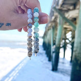Aqua tides or beachy blues with sandy jaspers